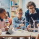 7 successful schools: Male teacher leans over table of 5 middle school students working on building models ofwind turbine power generators