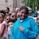 Bronx community grants, health organization support grants: group of happy black youth smiling and throwing "peace sign" at camera