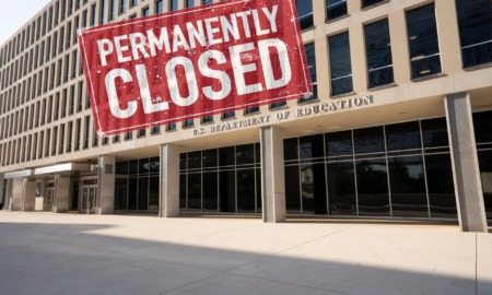 Close DOE Unlikel: DOE building -- beige, multistory, moder --- with red, grungy rectangle sign with white text "Permanently Closed"