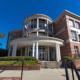 Rural college major elimination: Traditional 3-story red brick building with round tower and round white pillars with cement steps leading up to multiple doors