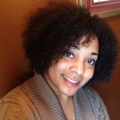 College listening cohort: Headshot Black woman with short black hair in tan top