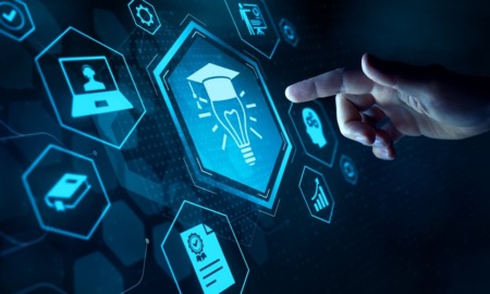 AI in education and college: Comouter screen dark blue with turquoise icons about AI with finger of hand approaching to touch screen from right side of image