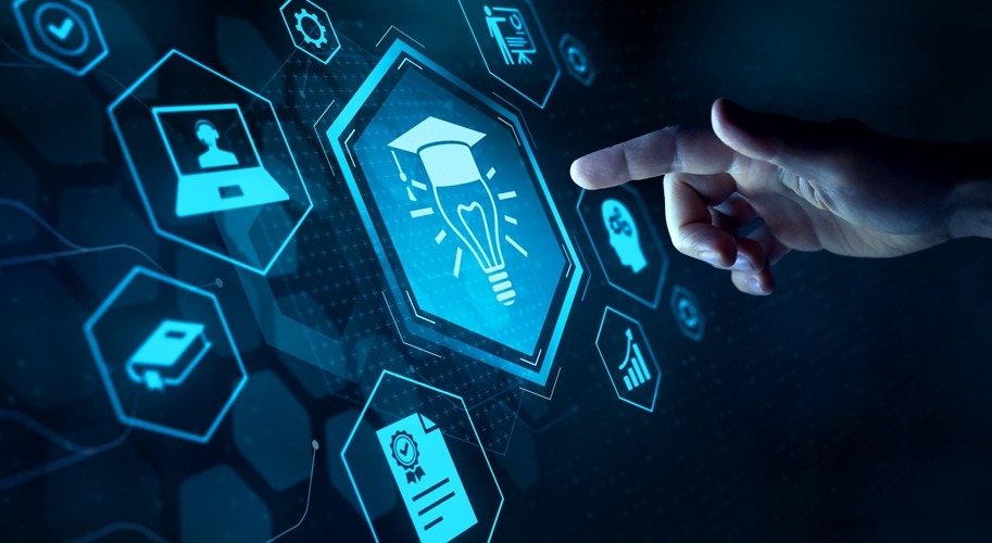 AI in education and college: Comouter screen dark blue with turquoise icons about AI with finger of hand approaching to touch screen from right side of image