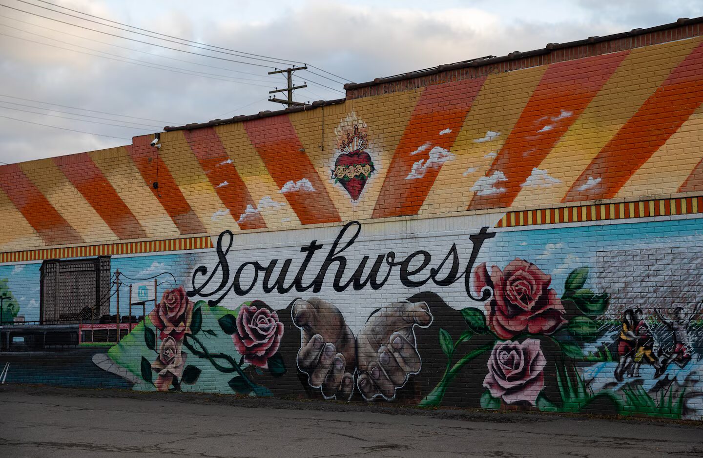 High school drop-out: Mural on one-story building in bright orange with yellow rats above huge multi-color flowers