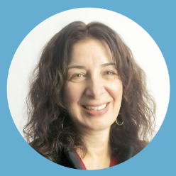 NYC immigrants prep for Trump: Middle age woman with long curly brown hair
