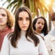 High school drop-outs: Close-up of four mixed ethnicity young adults - 2 women and two men - stare into camera with serious faces.