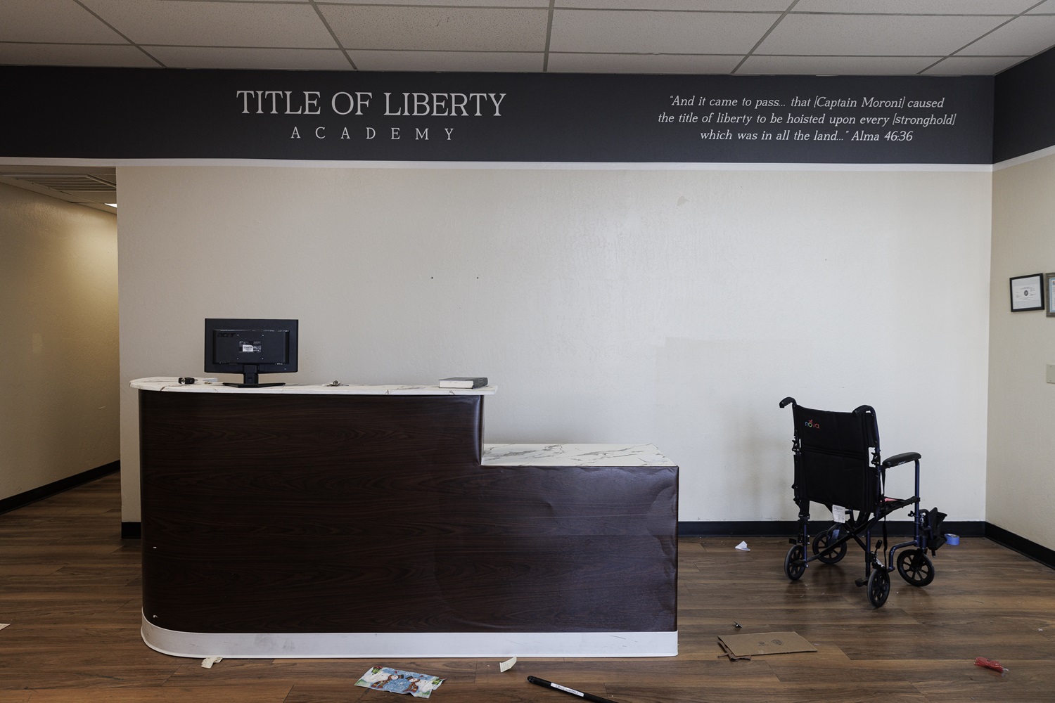 Arizona regulators closed failing charter school_It reopened private religious school funded by taxpayers: front lobby desk of abandoned academy with wheelchair off to the right