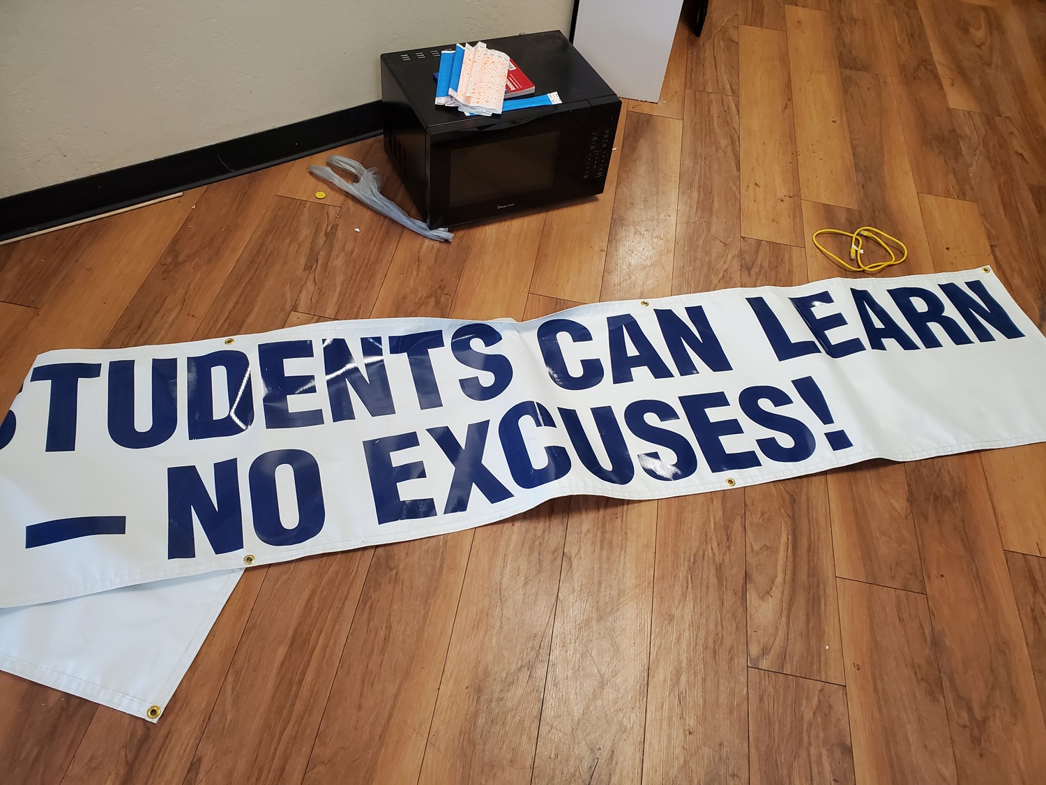 Arizona regulators closed failing charter school_It reopened private religious school funded by taxpayers: a banner on wood floor that reads: "“Students can learn — no excuses!”