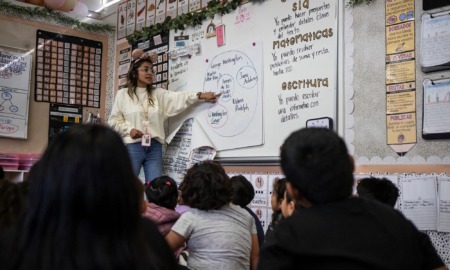 California banned bilingual education for almost 20 years. It still hasn’t recovered: young female teacher points at white board with circles and Spanish words on it