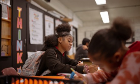 Maryland push to scale up high dosage math tutoring: black female student working at desk in school