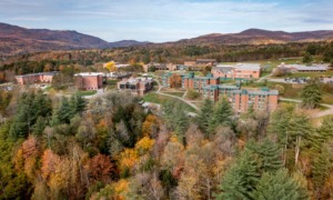 Colleges closing/merging: Vermont State University Johnson Campus in the distance surrounded by trees in fall colors