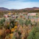 Colleges closing/merging: Vermont State University Johnson Campus in the distance surrounded by trees in fall colors