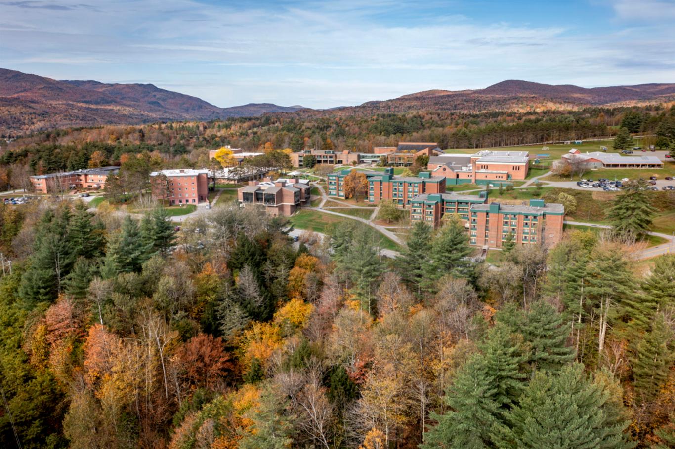 Colleges closing/merging: Vermont State University Johnson Campus in the distance surrounded by trees in fall colors