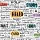 ilingual children: Word cloud of "hello" in multiple languages in handprinted text in black on white with some words in pastel-colored bubbles