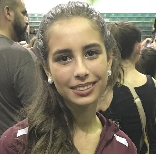 Trump guts school safety committee: Headshot teenage girl with long, light brown hair in burgundy polo shirt