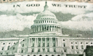 Federal funding pause: Close up of White House image on United States paper currency in green on off-white