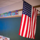 Education in 2025: American flag hanging in front of classroom chalkboard