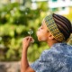 Black minds matter report on Black students in California: young black boy with colorful headband blows dandelion