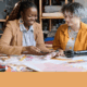 Disabled student programs DOGE cuts: Teen girl with black artificial arm sits with adult Black woman at table with sewing machines pinning cloth to pattern pieces