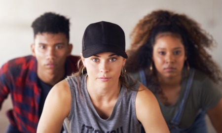Foster care aging out, older youth adoption: Headshot portrait of three serious teens -- one white female, one Black female and one Black male.