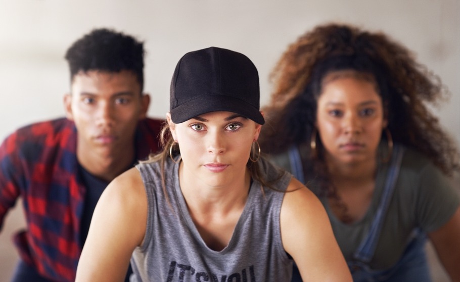 Foster care aging out, older youth adoption: Headshot portrait of three serious teens -- one white female, one Black female and one Black male.