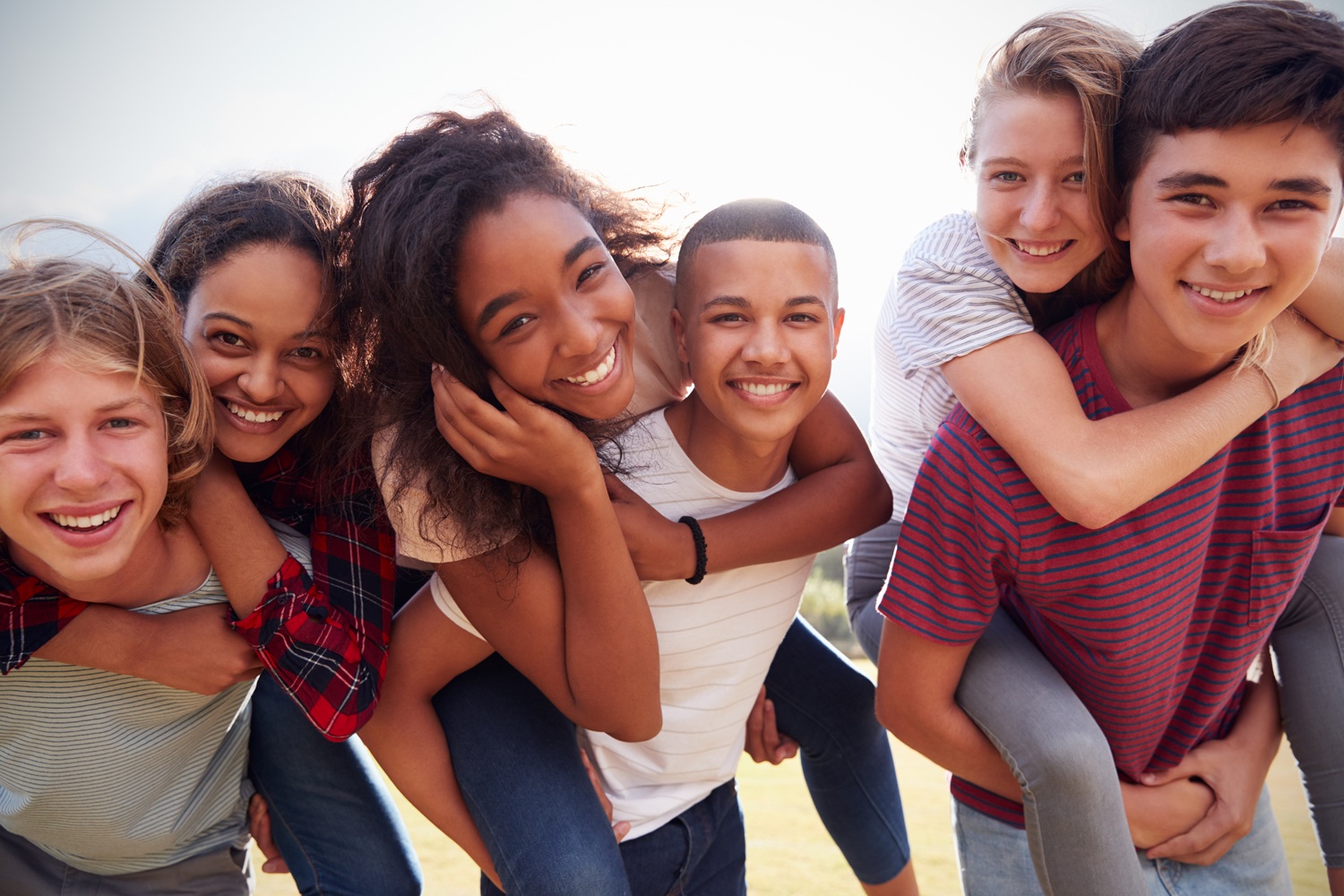 In adolescence every experience matters: group of happy youths smiling