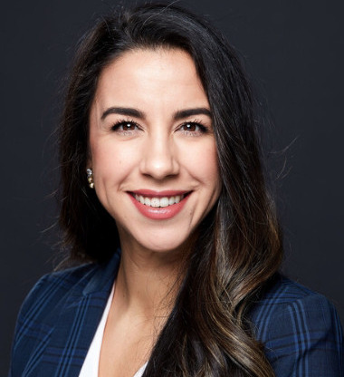 COVID funding halted: Headshot woman with long brunette hair in navy suit with white top