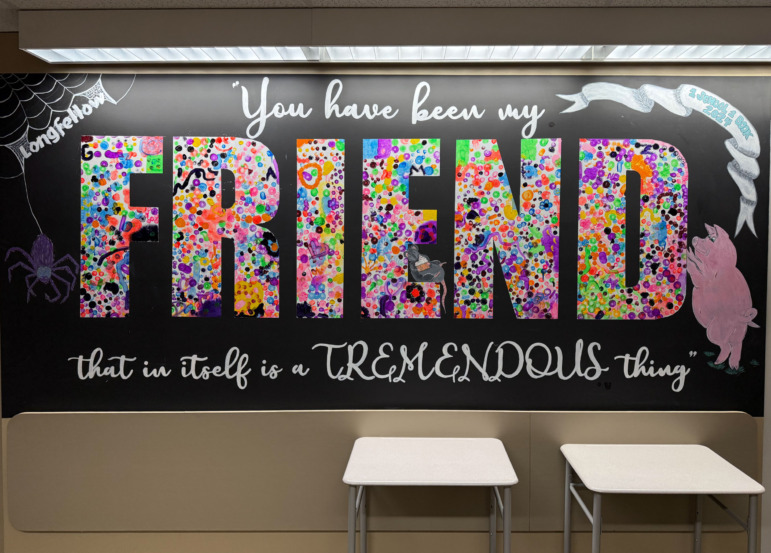 Cell phone alternative activities: Large poster on classroom wall with multi color text "Friends" on black background