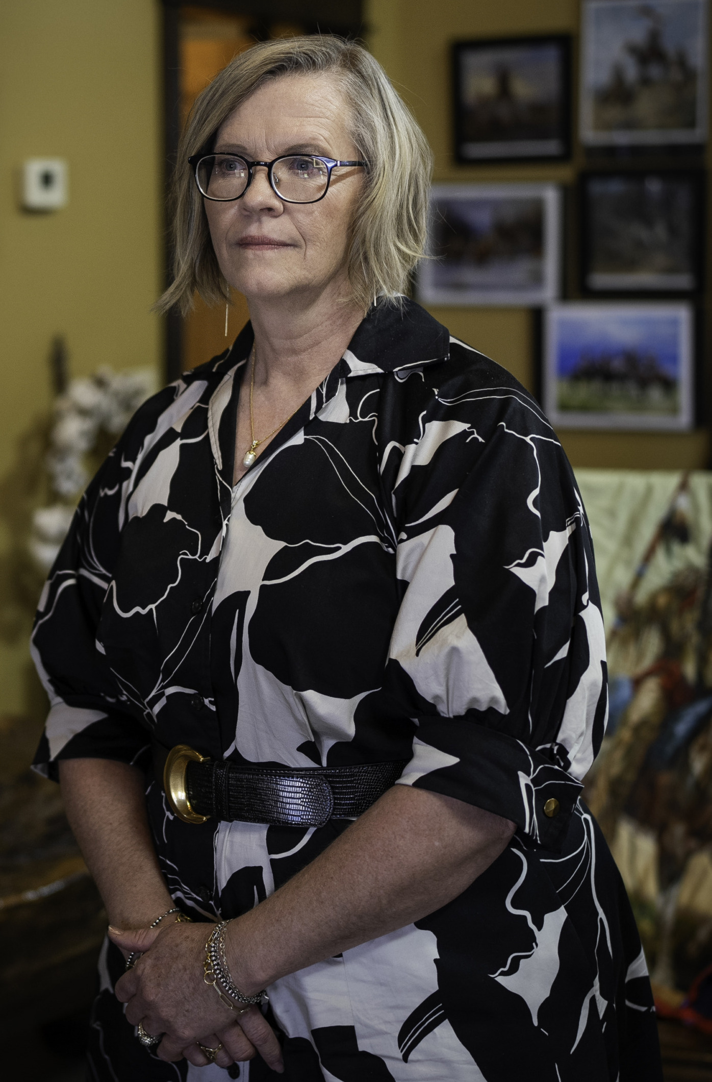 Whooping Cough & Measles outbreak: Woman with bobbed blonde hair and glasses in black and white print blouse