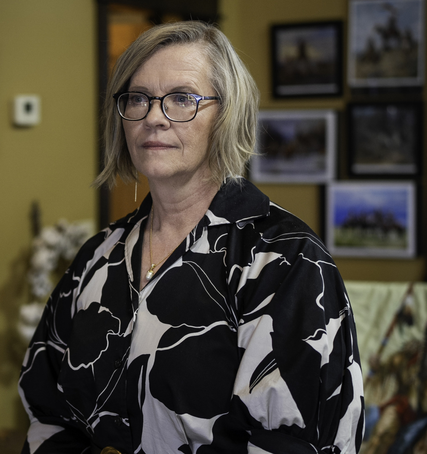 Whooping Cough & Measles outbreak: Woman with bobbed blonde hair and glasses in black and white print blouse