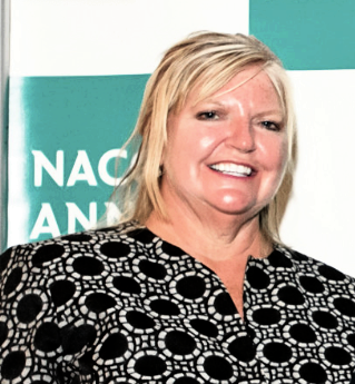 Whooping Cough & Measles outbreak: Woman with short blonde hair in black and white geometric print blouse
