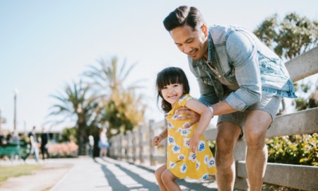 San Diego AANHPI youth mental health grants: young father and child having fun on sunny day near beach