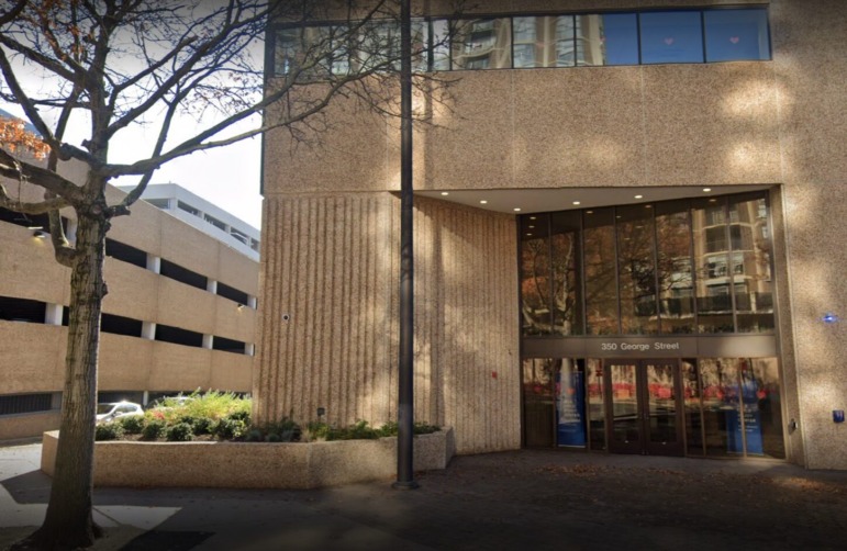 Legal counseling for behavior issues: Front of modern multi-story, tan textured building with large , dark glass, front doors surrounded by large windows with address above doors — 350 George Street