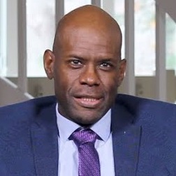 US Supreme Court religious charter school case:: Headshot Balding Black man in Blue suit, lavender shirt and purple tie