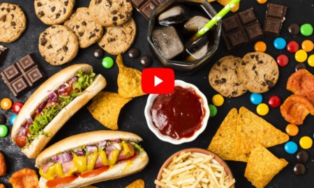 MAHA report on processed foods and kids health: Overhead view table full of processed foods, chips and candy.