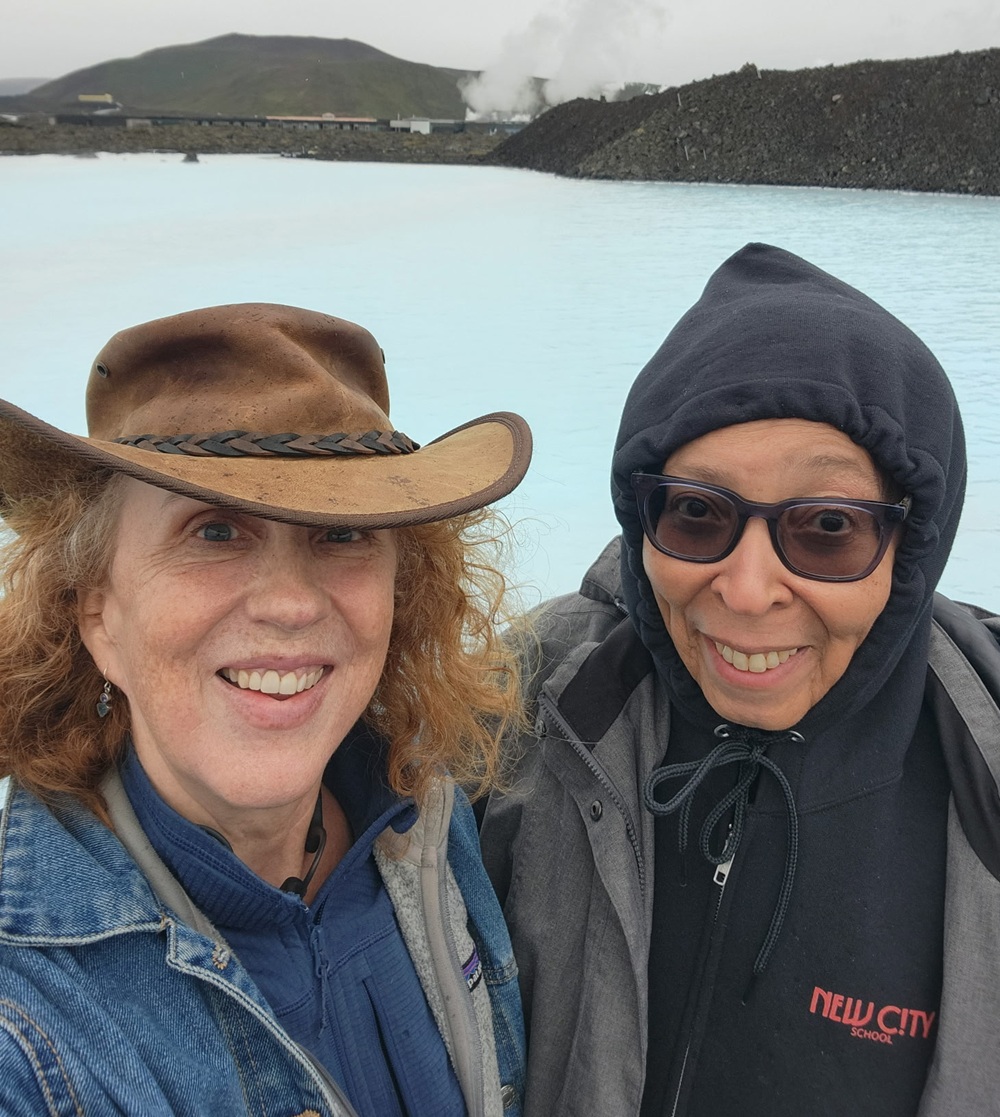 New opportunities to explore extended learning and youth development across the globe: two women take a selfie in front of blue lagoon