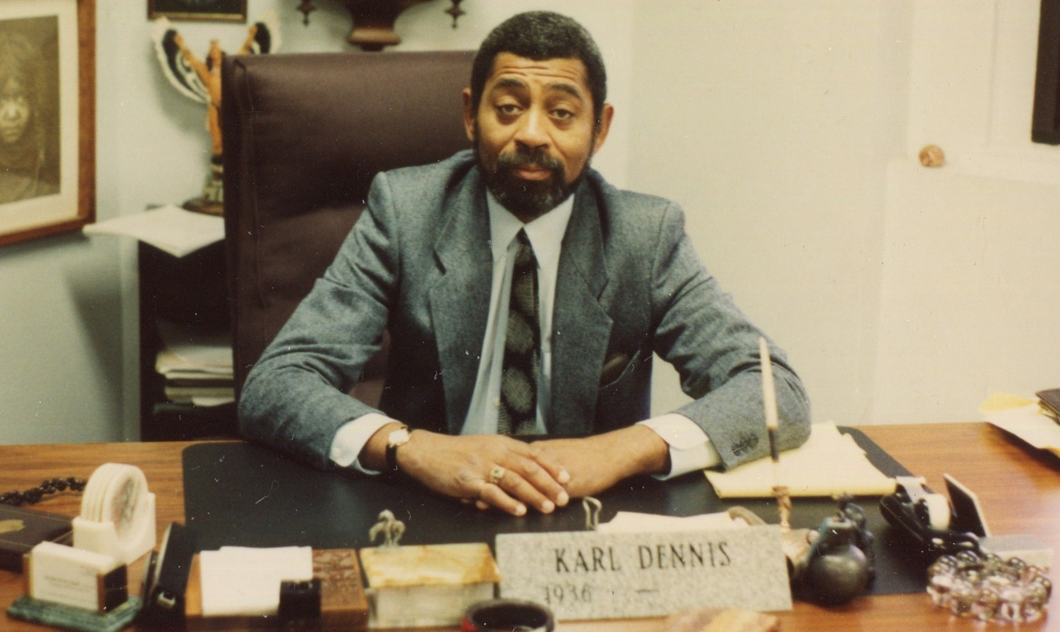 The path blazed by Karl Dennis_Father of Wraparound, wraparound services: old photo of black man in suit sitting at desk