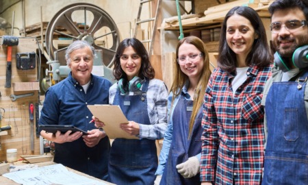 women and girls' support in apprenticeships grants: group of three young women and one young man learning how to work in lumberyard