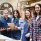 women and girls' support in apprenticeships grants: group of three young women and one young man learning how to work in lumberyard