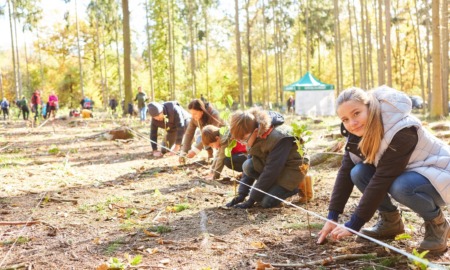 Youth-led climate change organization grants: young people planting trees in reforestation project