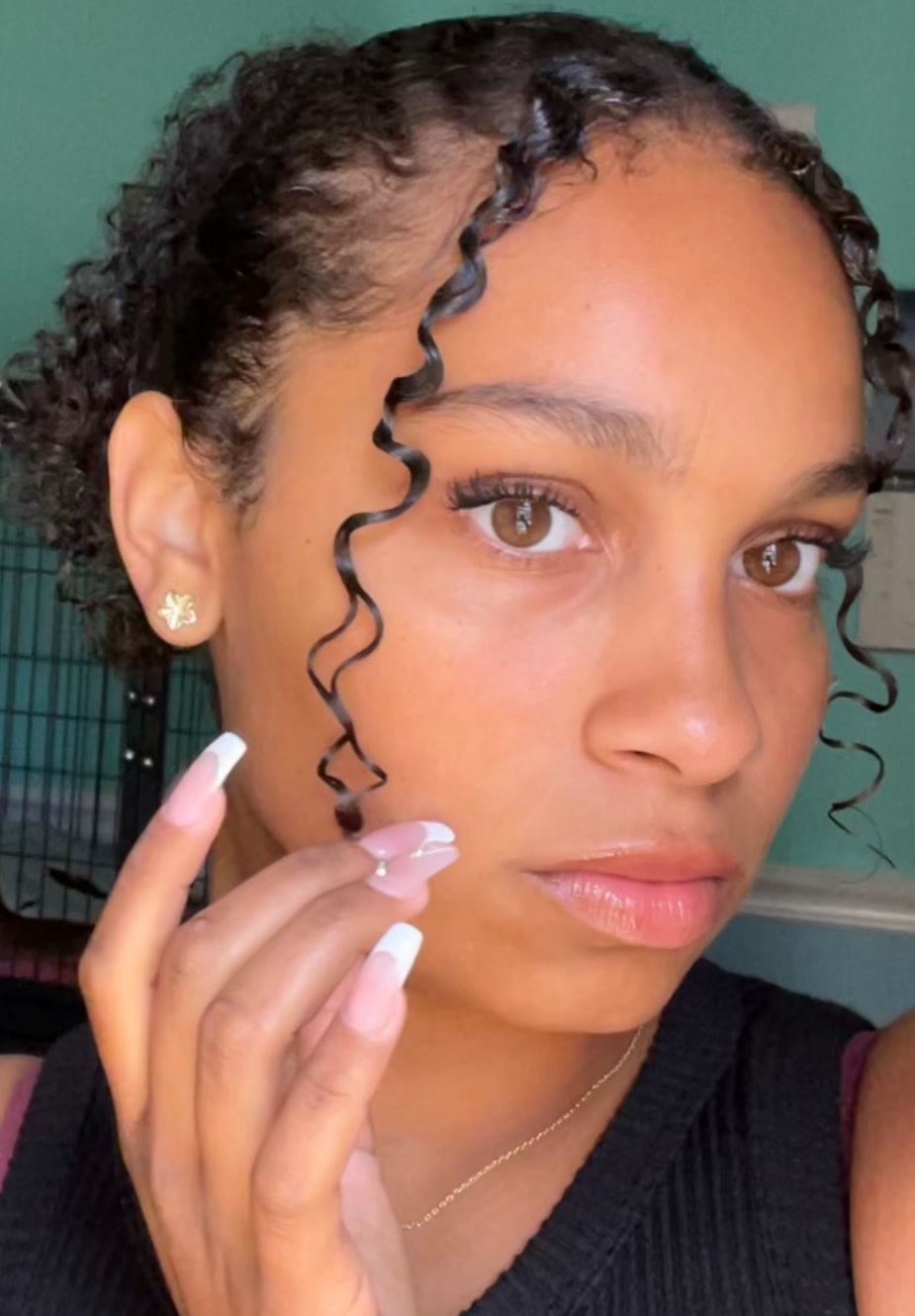 Erika Easy headshot: young black female student with hand by face