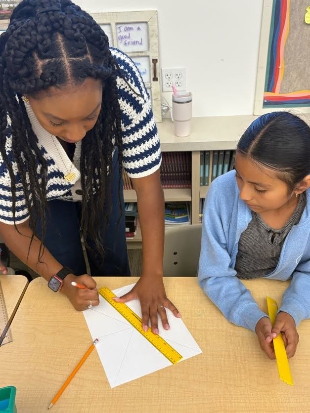 Expanding horizons, essential relationships_The evidence of afterschool impacts_angles: educator helps student at table using ruler to draw angles