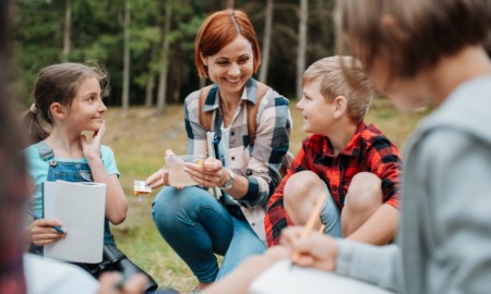 From turnover to graduation_Rethinking out-of-school time staff retention: education/youth professional working with students outdoors