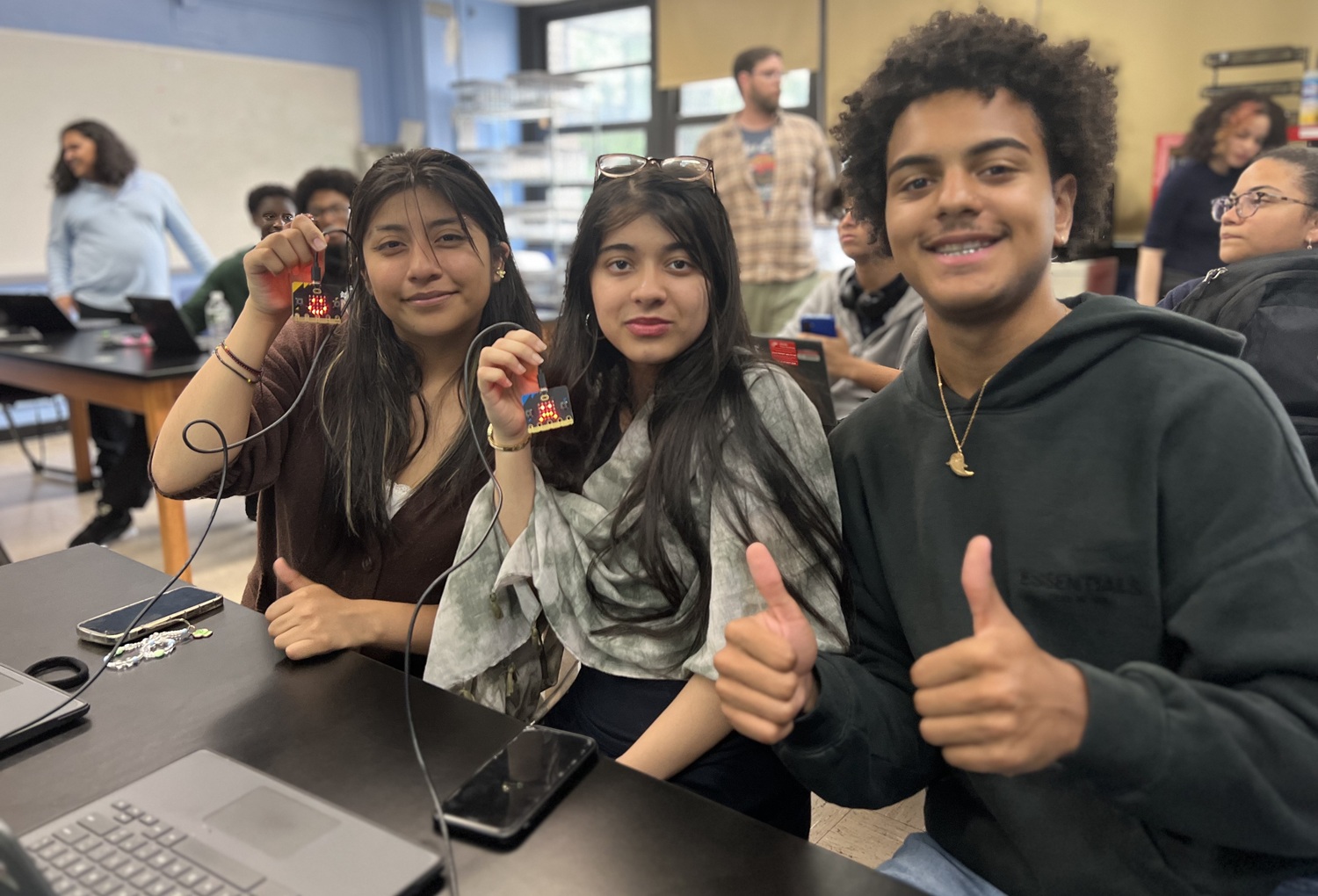 What happens when Bronx students lead the way in STEM equity _feature: two female and one male student pose for picture, females are holding computer chips