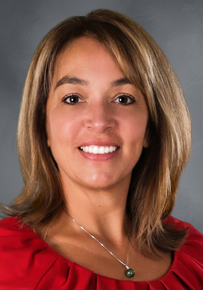 Christine Blake headshot: woman with shoulder-length hair in red shirt smiling