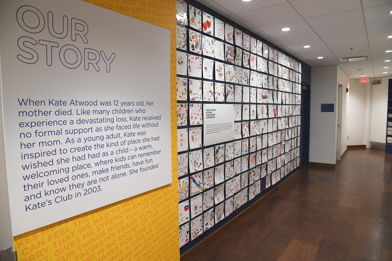 Evolving with teens_Building programs to keep them connected through grief_clubhouse memory wall: wall of kids drawings and text saying "Our Story"
