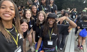 Evolving with teens_Building programs to keep them connected through grief_feature: group of teen girls in matching black shirts smiling