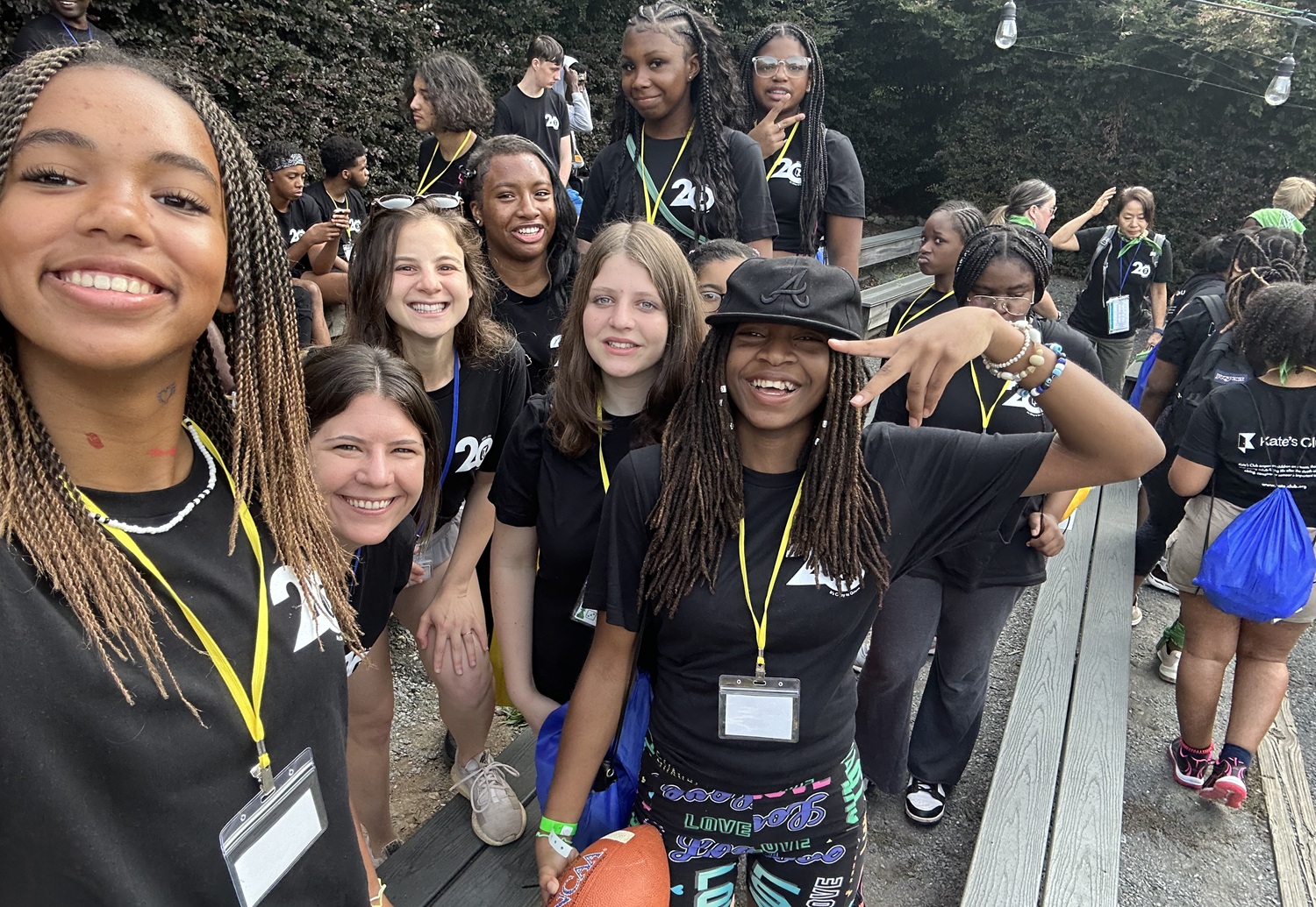 Evolving with teens_Building programs to keep them connected through grief_feature: group of teen girls in matching black shirts smiling