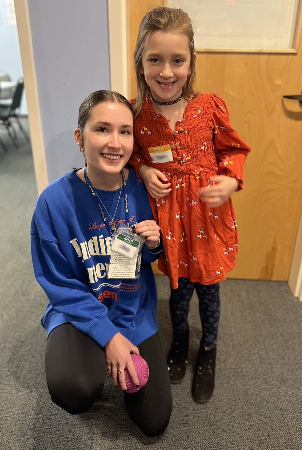 Evolving with teens_Building programs to keep them connected through grief_teenandgirl: female teen and young girl pose for picture in hallway