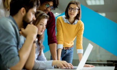 QA with Michael Crawford America Succeeds_feature: group of young office workers working together on laptop at table